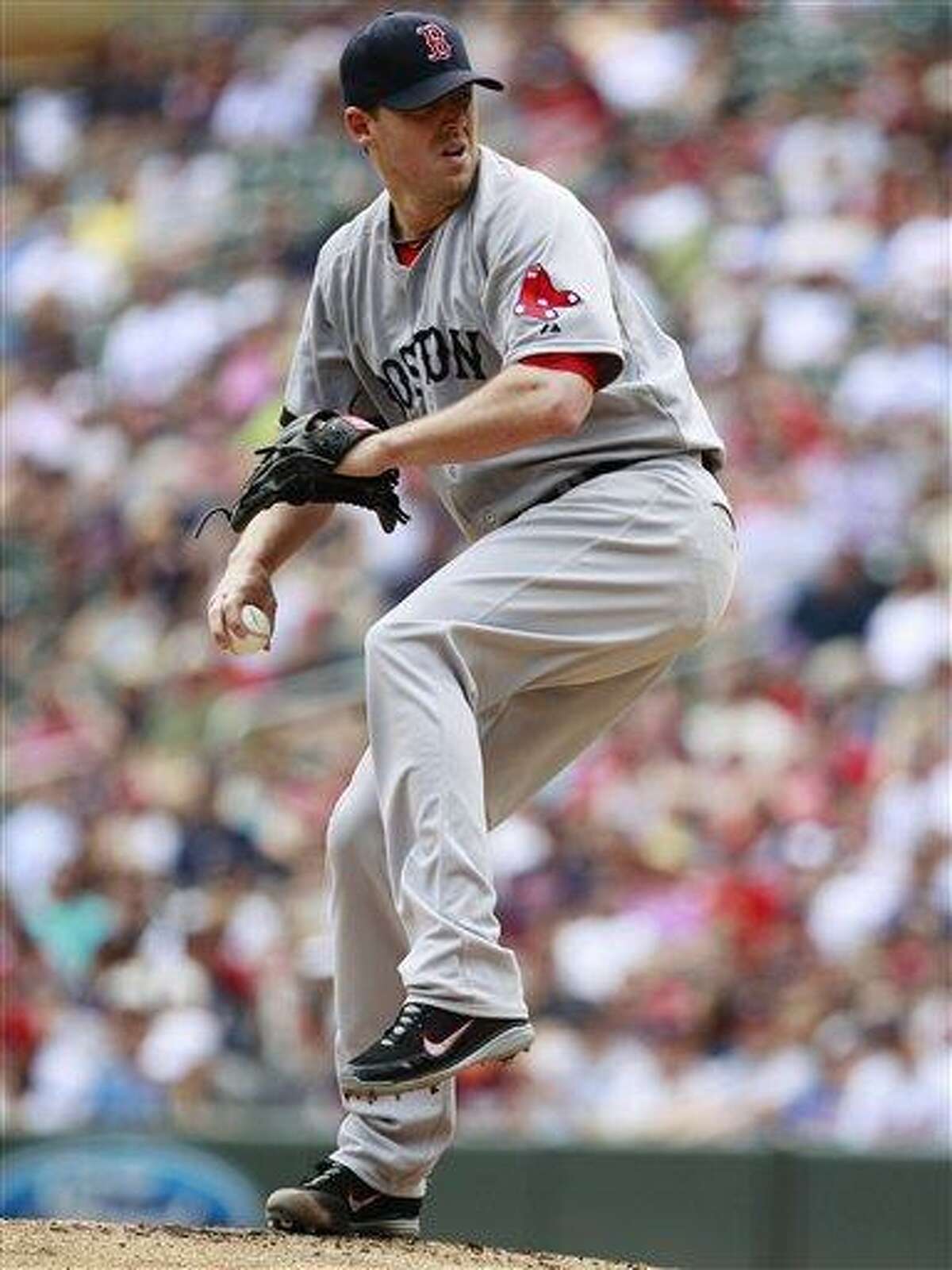 Boston Red Sox starting pitcher John Lackey (41) throws against the Minnesota Twins during the inning inning of a baseball game, Sunday, May 19, 2013, in Minneapolis. (AP Photo/Genevieve Ross)