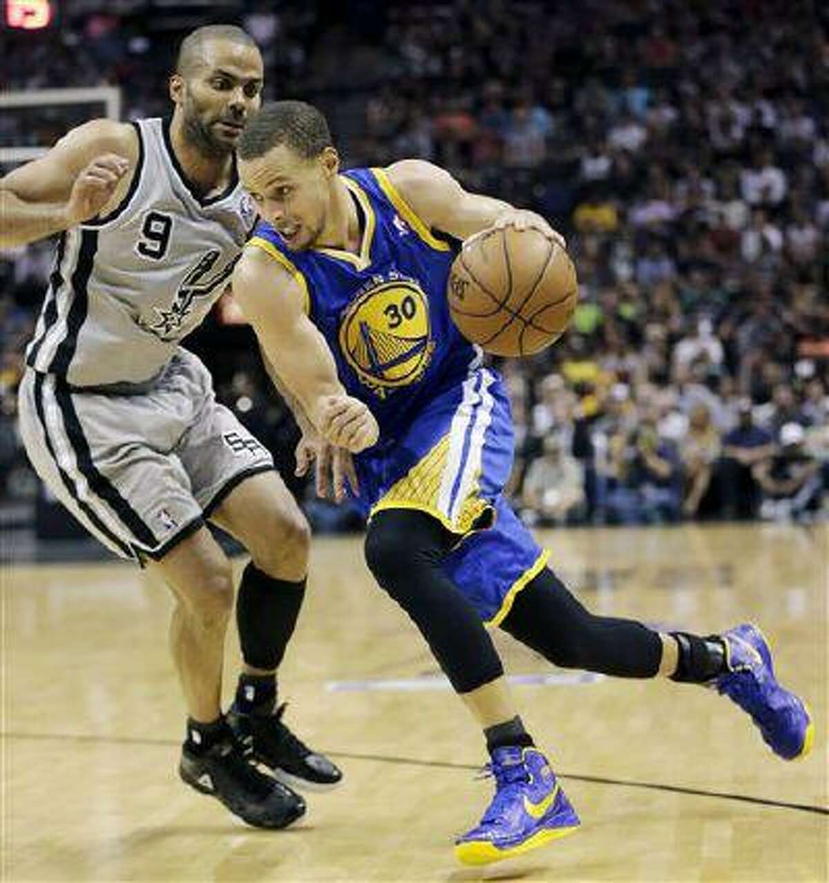 Golden State Warriors' Stephen Curry (30) drives on San Antonio Spurs' Tony Parker (9) during the second half in Game 5, May 14, 2013, in San Antonio.