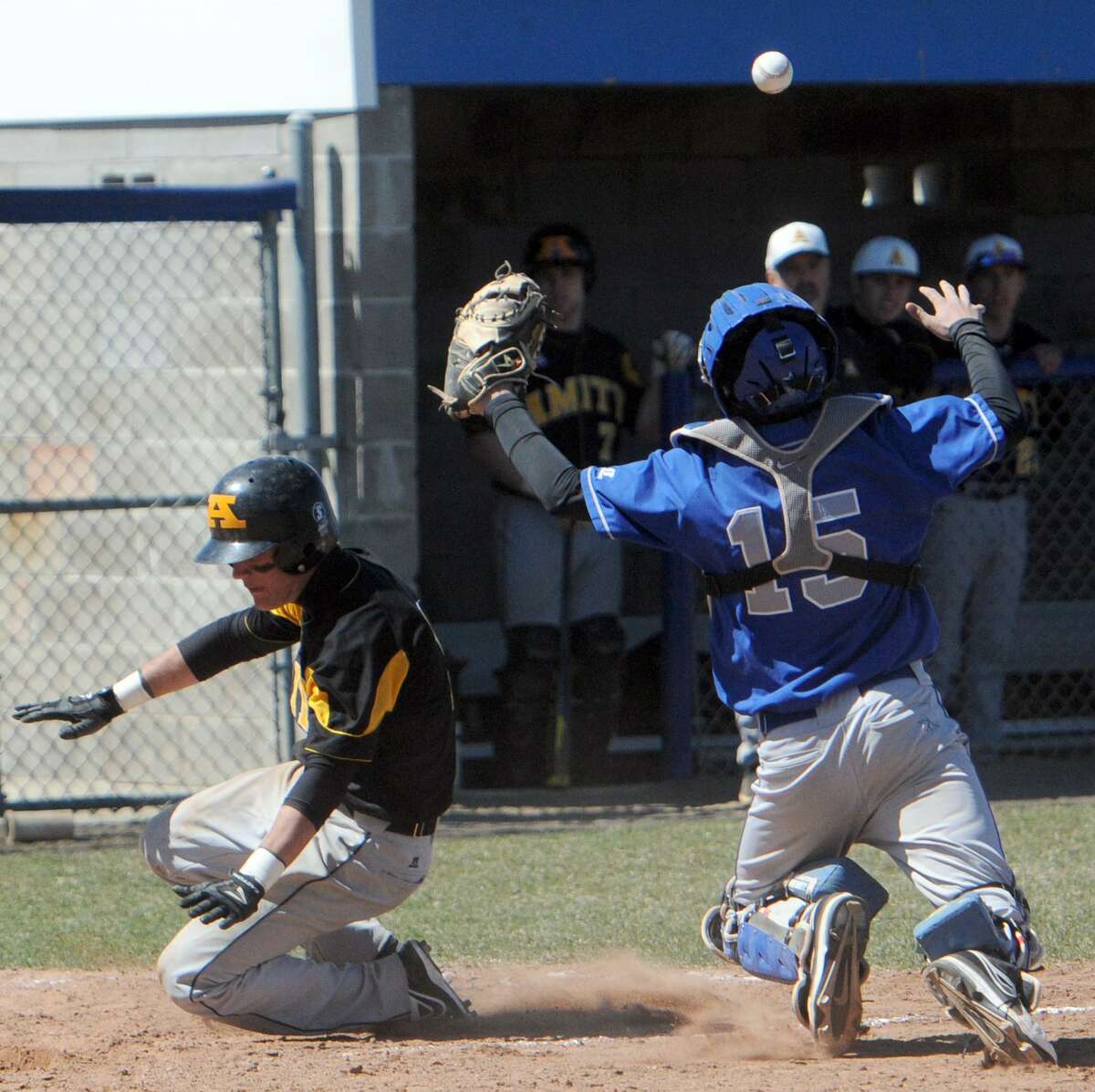 Jake Russo of Amity, left, slides into home plate for a run against West Haven earlier this season. Amity fell to Xavier on Monday. Photo by Peter Hvizdak / New Haven Register.