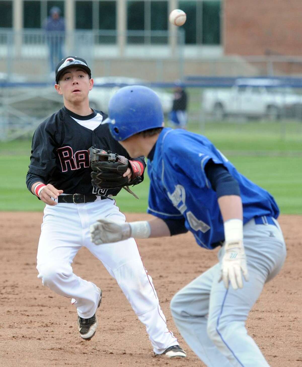 Cheshire's Tommy Savino, left, West Haven's Mike Brand caught in a rundown between 2nd and 1st base. West Haven won 2-1 in 8 innings. Mara Lavitt/New Haven Register mlavitt@newhavenregister.com