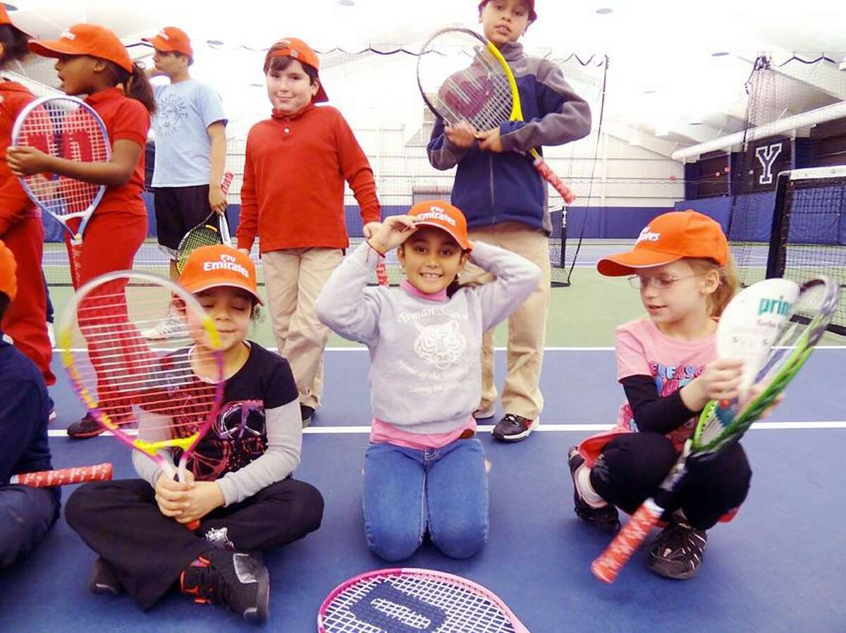 More than 100 racquets were collected as part of the Emirates Airlines Racquet Return program during the 2012 New Haven Open at Yale and refurbished for kids from New Haven Youth Tennis & Education. Some of the children received them recently at an event at the Cullman-Heyman Tennis Center. (Photo courtesy of New Haven Open)