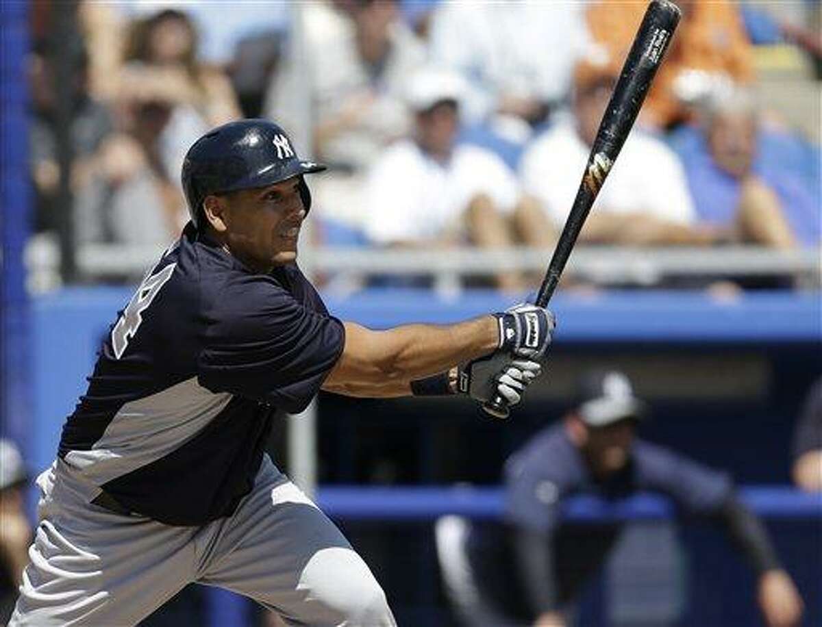 New York Yankees' Juan Rivera hits a fifth-inning three-run double off Toronto Blue Jays pitcher Brett Cecil in a spring training baseball game at Steinbrenner Field in Dunedin, Fla., Sunday, March 10, 2013. (AP Photo/Kathy Willens)