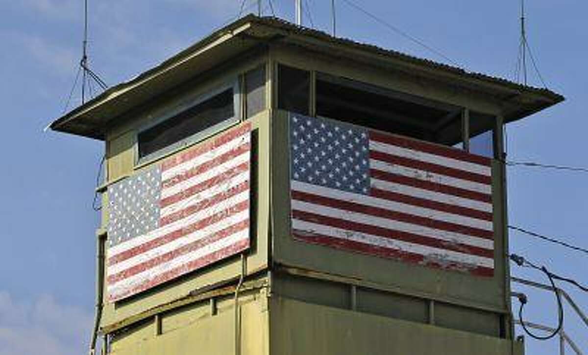 A U.S. Marine guard tower overlooks the Northeast gate leading into Cuba territory at Guantanamo Bay U.S. Naval Base, March 8, 2013.