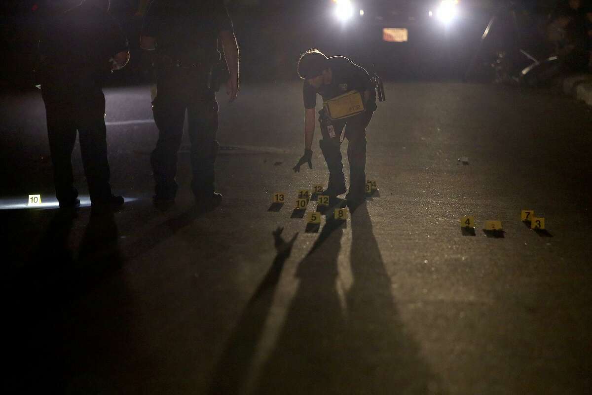 San Antonio police work the scene of a shooting on Fargo Avenue on the East Side in San Antonio on March 29, 2016. The City Council district that includes that area had the highest number of homicides in the city last year.
