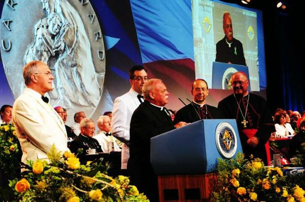 Monsignor Robert Weiss, and Grand Knight Timothy Haas of Newton, Conn., accept the inaugural Caritas Awards for exemplary works of charity at the States Dinner of the 131st Knights of Columbus Supreme Convention. The award was presented by Supreme Knight Carl Anderson and Supreme Chaplain Archbishop William E. Lori of Baltimore. Also present was Cardinal Timothy Dolan of New York and nearly 90 bishops and cardinals from around the world. Contributed photo.