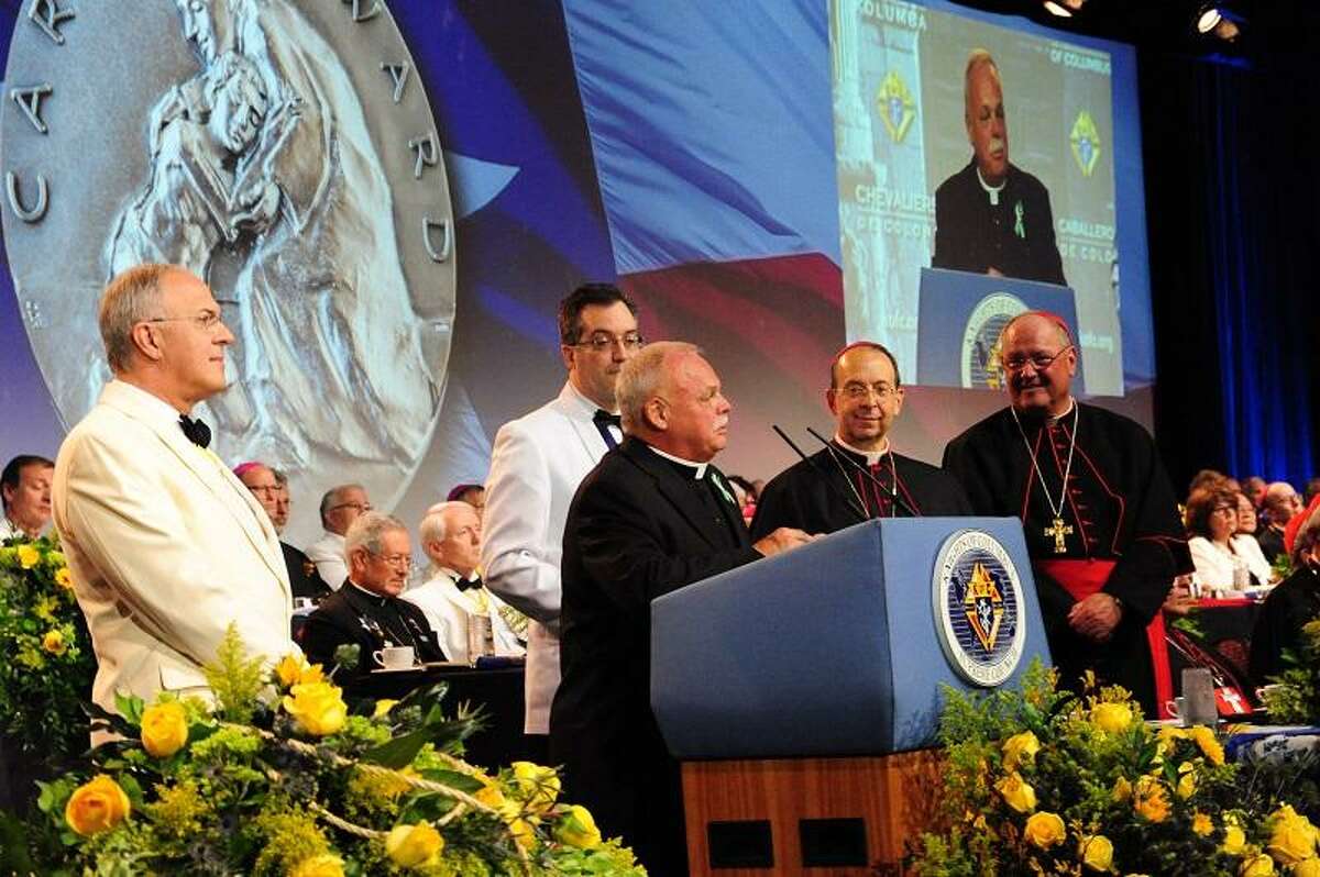 Monsignor Robert Weiss and Grand Knight Timothy Haas of Newton, Conn., accept the inaugural Caritas Awards for exemplary works of charity at the States Dinner of the 131st Knights of Columbus Supreme Convention. The award was presented by Supreme Knight Carl Anderson and Supreme Chaplain Archbishop William E. Lori of Baltimore. Also present was Cardinal Timothy Dolan of New York and nearly 90 bishops and cardinals from around the world.