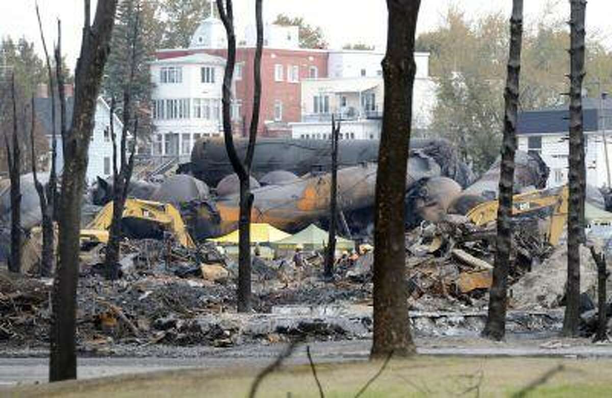 An emergency worker stands on the site of the train wreck in Lac Megantic, July 16, 2013.