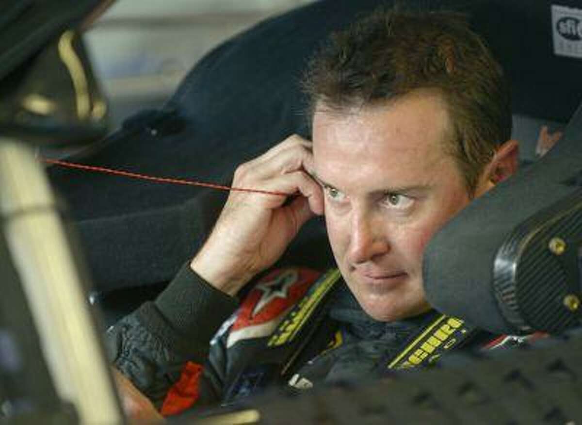 Kurt Busch adjusts his earplugs as he prepares to drive in a practice session for the NASCAR Sprint Cup auto race at Daytona International Speedway, Thursday, July 4, 2013, in Daytona Beach, Fla.