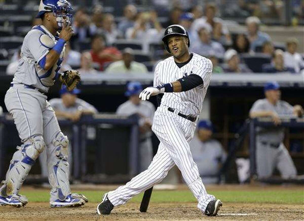 New York Yankees' Robinson Cano reacts after striking out swinging with a runner on second in the eighth inning of a baseball game against the Kansas City Royals, Tuesday, July 9, 2013, in New York. Royals catcher Salvador Perez is at left. (AP Photo/Kathy Willens)