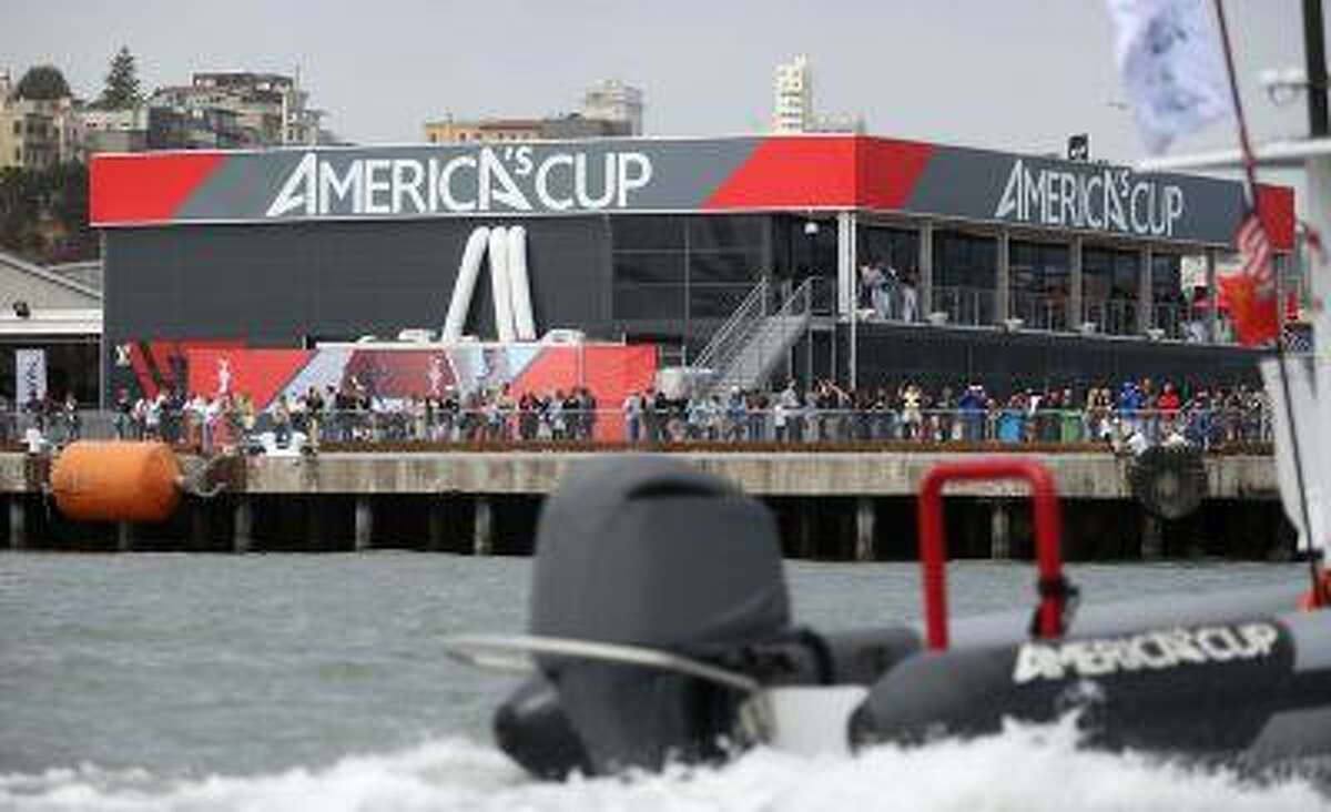 Spectators watch from the America's Cup park at Pier 27 during the America's Cup Parade of Boats in San Francisco, Calif., on Friday, July 5, 2013.