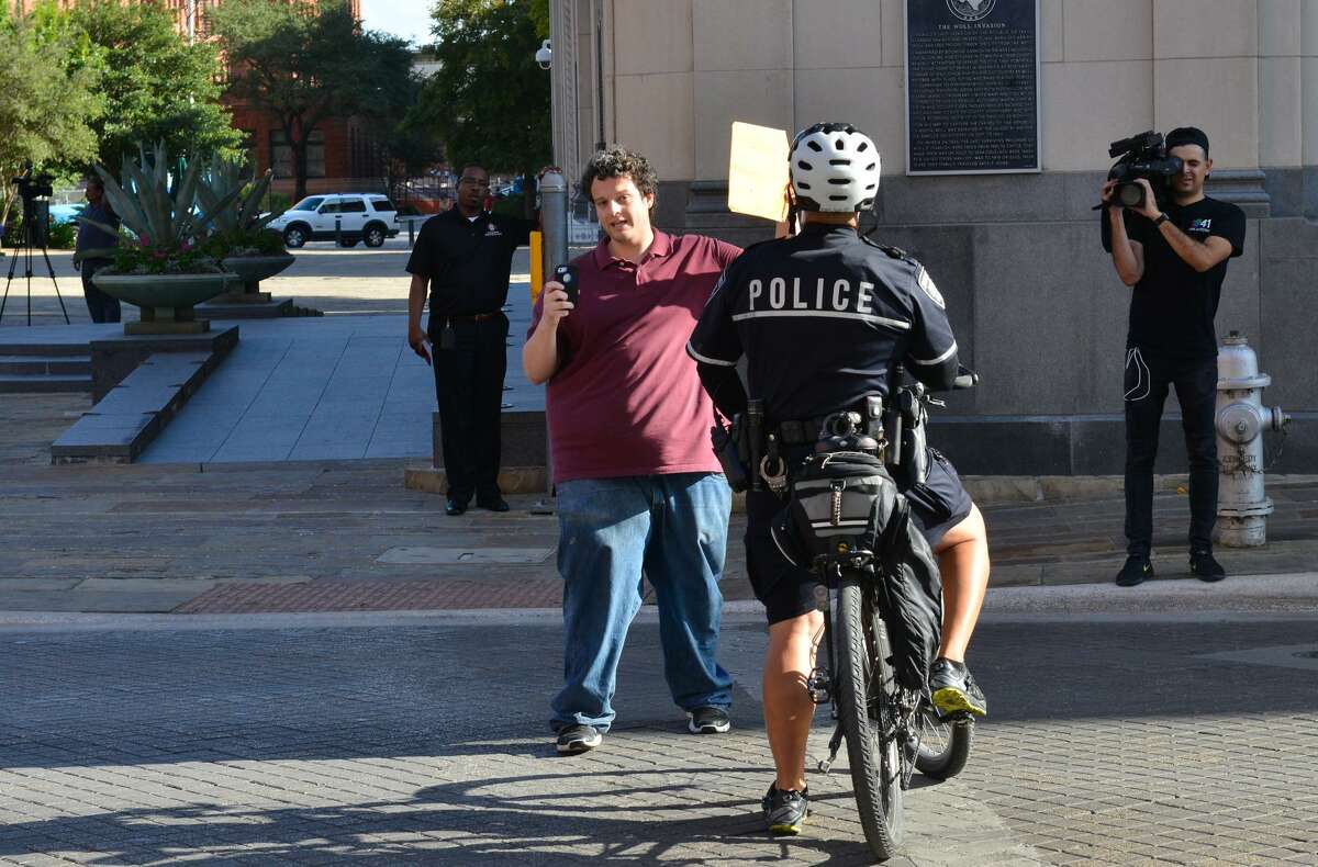 Matt Lerma is asked to get out of Commerce Street by a San Antonio police officer while yelling at a group from “This is Texas Freedom Force” before a San Antonio City Council meeting regarding the removal of a Confederate statue from Travis Park.