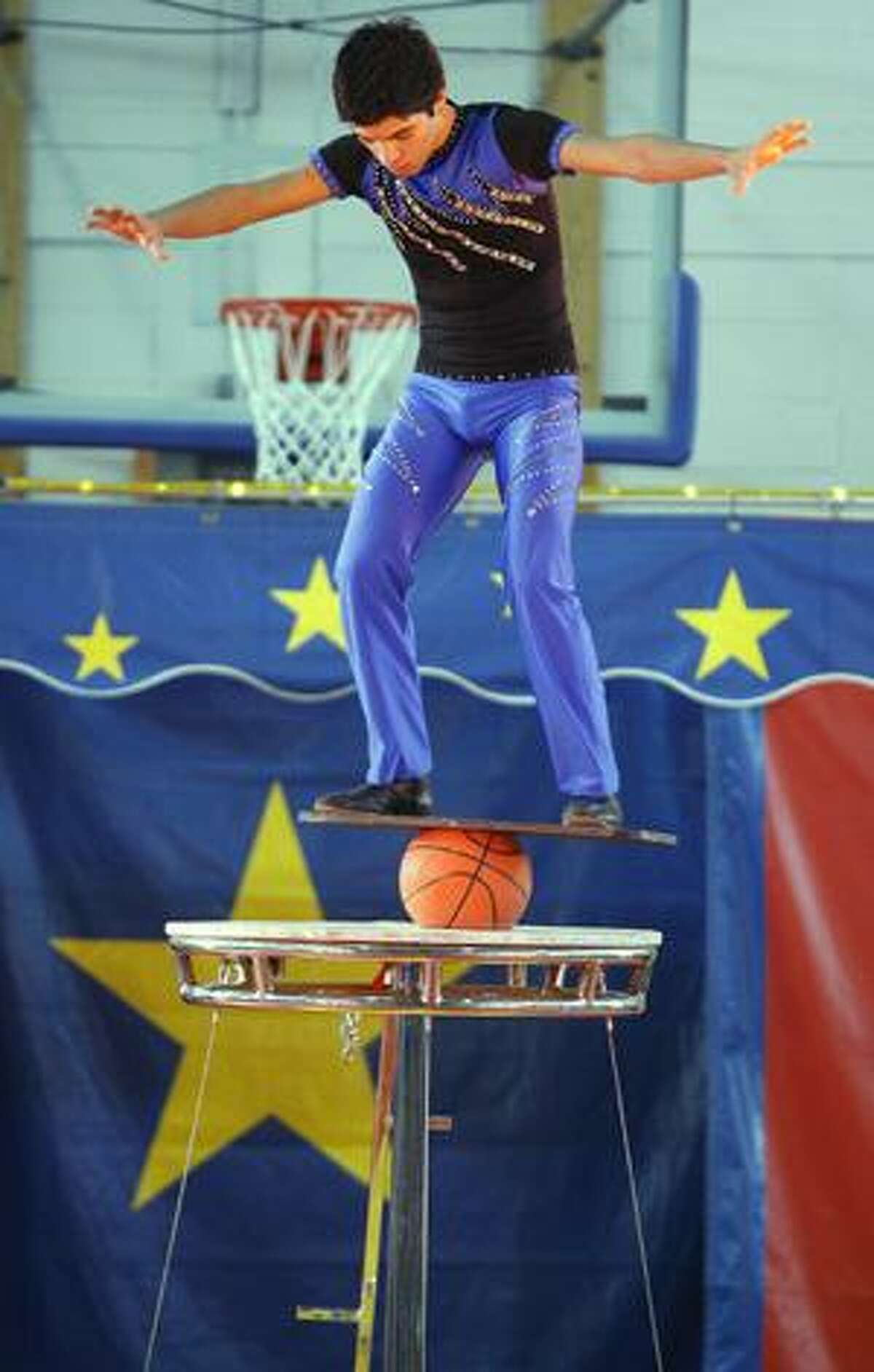 Photo by JOHN HAEGER A circus performer balances atop a basketball during the Billy Martin's Cole All-Star Circus on Saturday, Jan. 29, 2011 at Oneida High School. The circus was sponsored by the Zonta Club of Oneida.