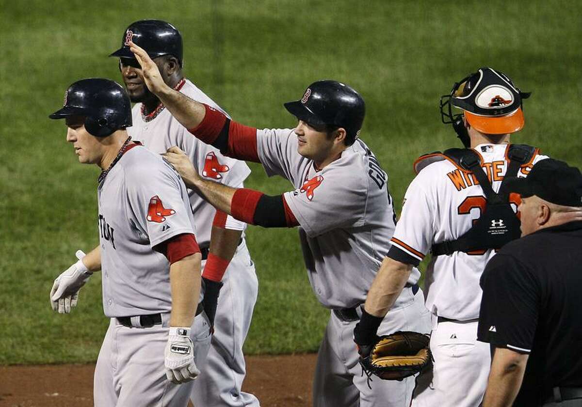The Red Sox's Ryan Lavarnway, left, walks away from home plate with teammates David Ortiz, second from left, and Adrian Gonzalez after Lavarnway drove them in on a home run in the fourth inning of Tuesday's game against the Baltimore Orioles. The former Yale star added a second homer as Boston won 8-7. (AP photo)