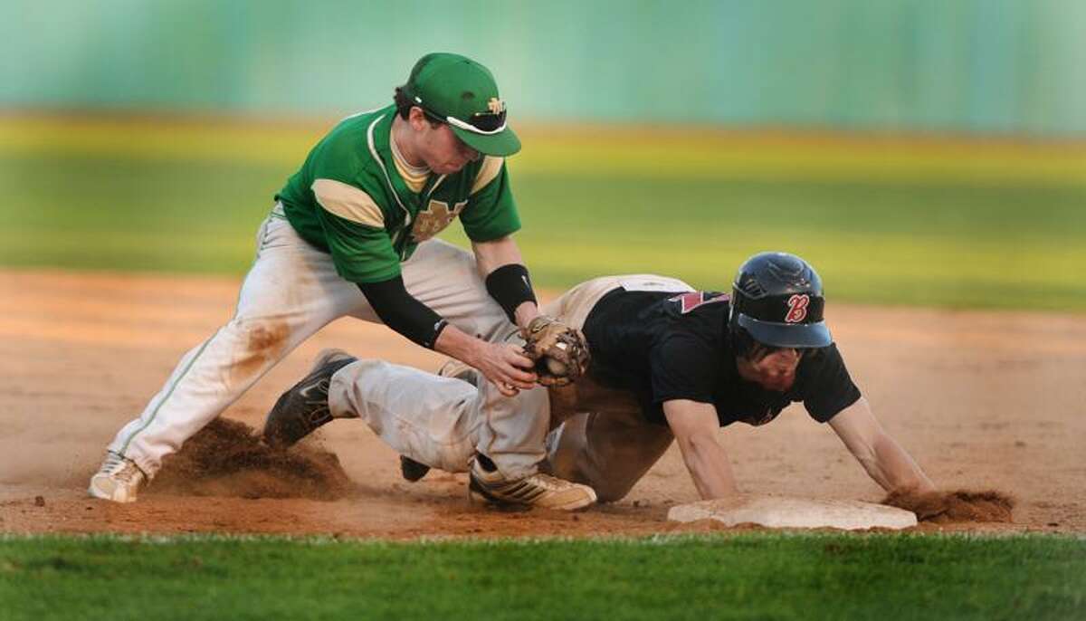 Branford's Samuel Kraszewski dives back to 1st base in time to aviod being picked off in the 3rd inning of the SCC tournament quarterfinal game against Notre Dame. Trying for the tag is Notre Dame's Michael Panza Melanie Stengel/Register