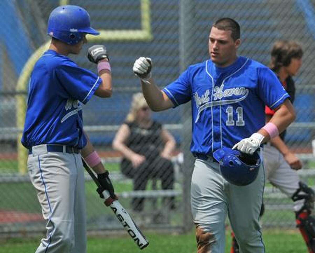 West Haven's Tom Spencer, right, is greeted by J.P. Withington after crossing the plate during Saturday's game versus Platt Tech. Photo by Brad Horrigan/New Haven Register.
