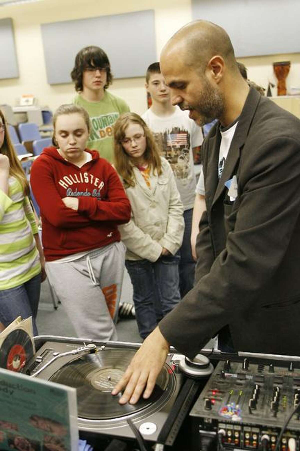 Photo by JOHN HAEGER Otto Shortell Middle School seventh-graders watch DJ Marc Tucci talk about his career and tools of his trade during a career fair held at the school on Tuesday, May 17, 2011.