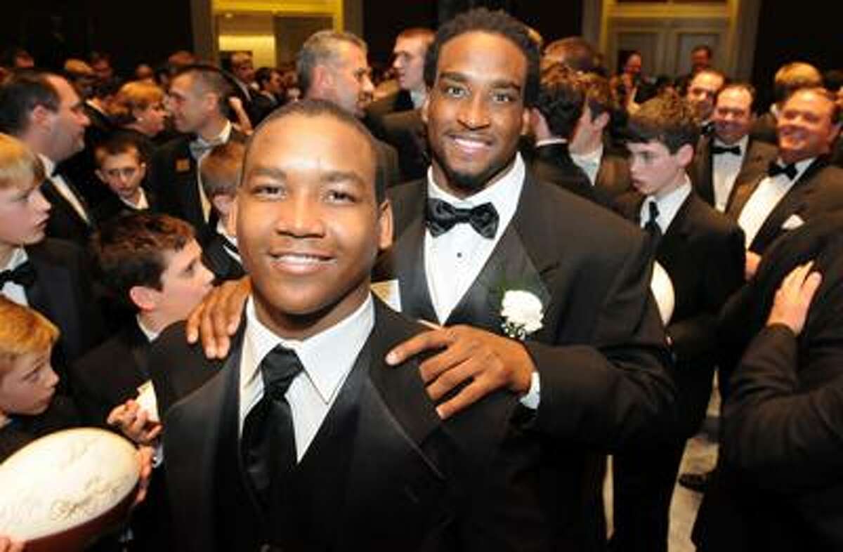 Yale University was the site of the annual Walter Camp dinner highlighting the Walter Camp Award winners and All-America team. Shaky Smithson right is a team member here with his 16 year old brother Anthony, both of Salt Lake City. Photo by Mara Lavitt/New Haven Register1/15/11