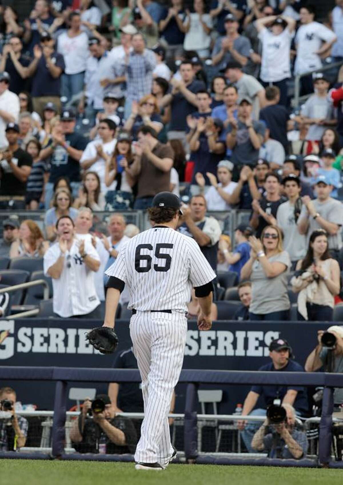 New York Yankees starting pitcher Phil Hughes is cheered by fans as he leaves a baseball game against the Seattle Mariners in the eighth inning on Saturday, May 12, 2012 in New York. The Yankees won the game 6-2. (AP PhotoPeter Morgan)