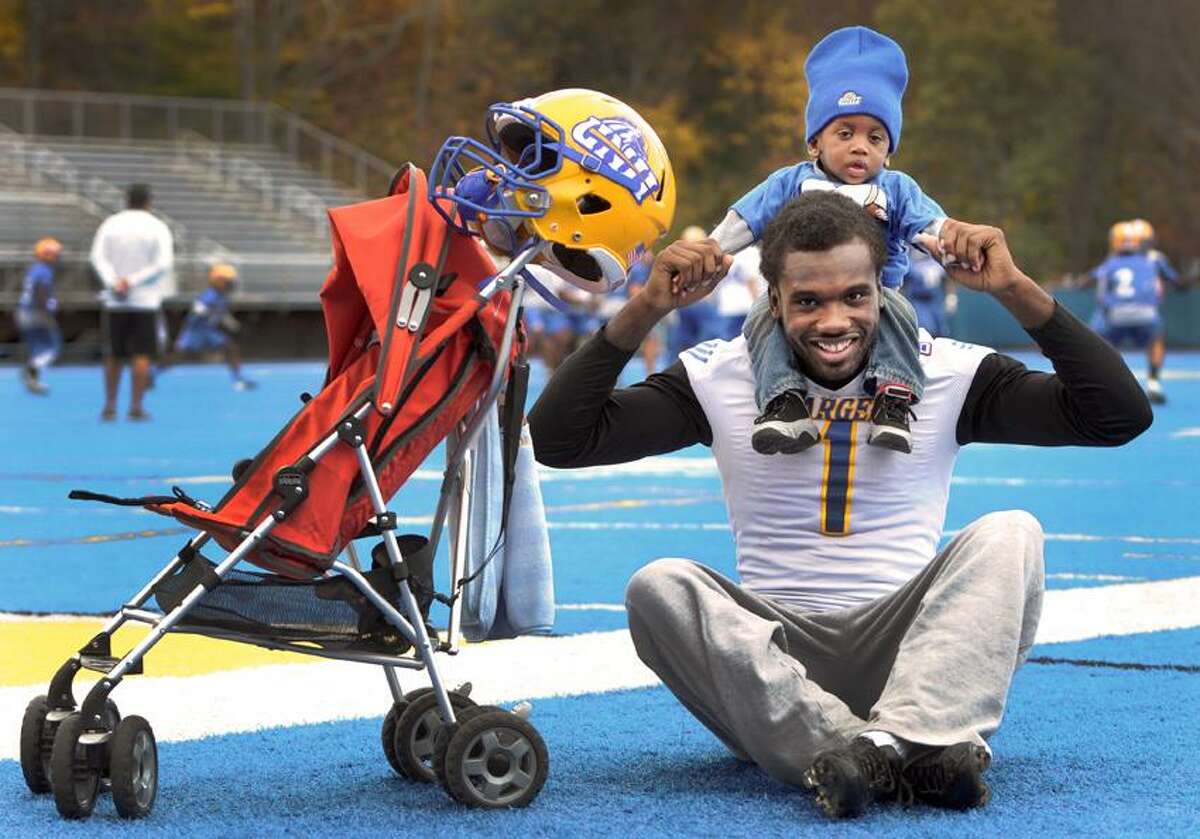 Demetrius Washington-Ellison, wide receiver for the University of New Haven football team, with his son Demetrius Washington-Ellison, Jr. at Ralph DellaCamera Stadium at the University of New Haven in West Haven.Thursday October 25, 2012. Photo by Peter Hvizdak / New Haven Register