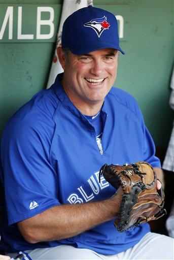 Boston Red Sox pitching coach John Farrell (C) and catcher Jason