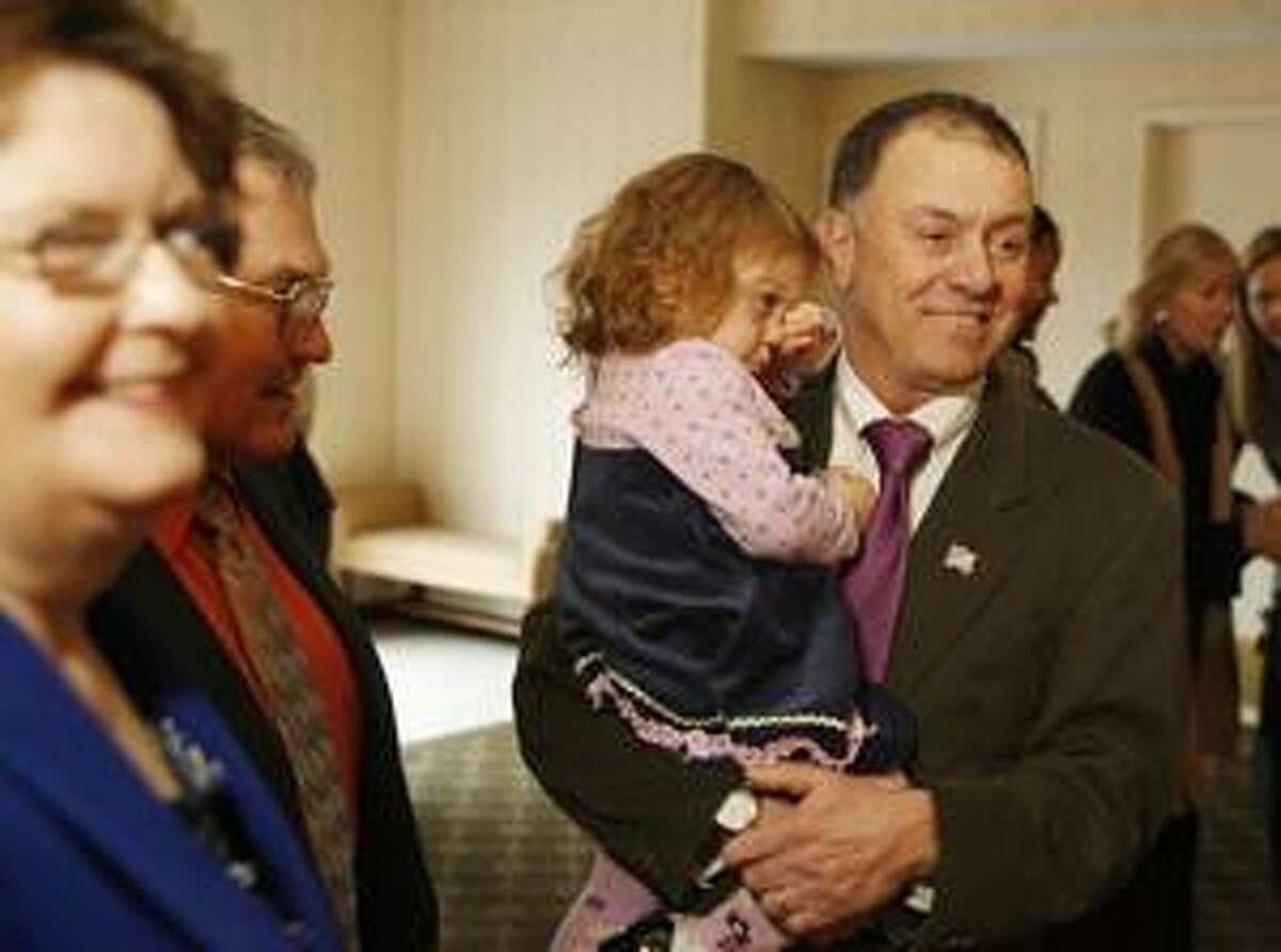 Photo by JOHN HAEGER Richard Hanna holds his daughter Grace, 2, as he talks with supporters at the Hotel Utica on Sunday, Jan. 2, 2011.