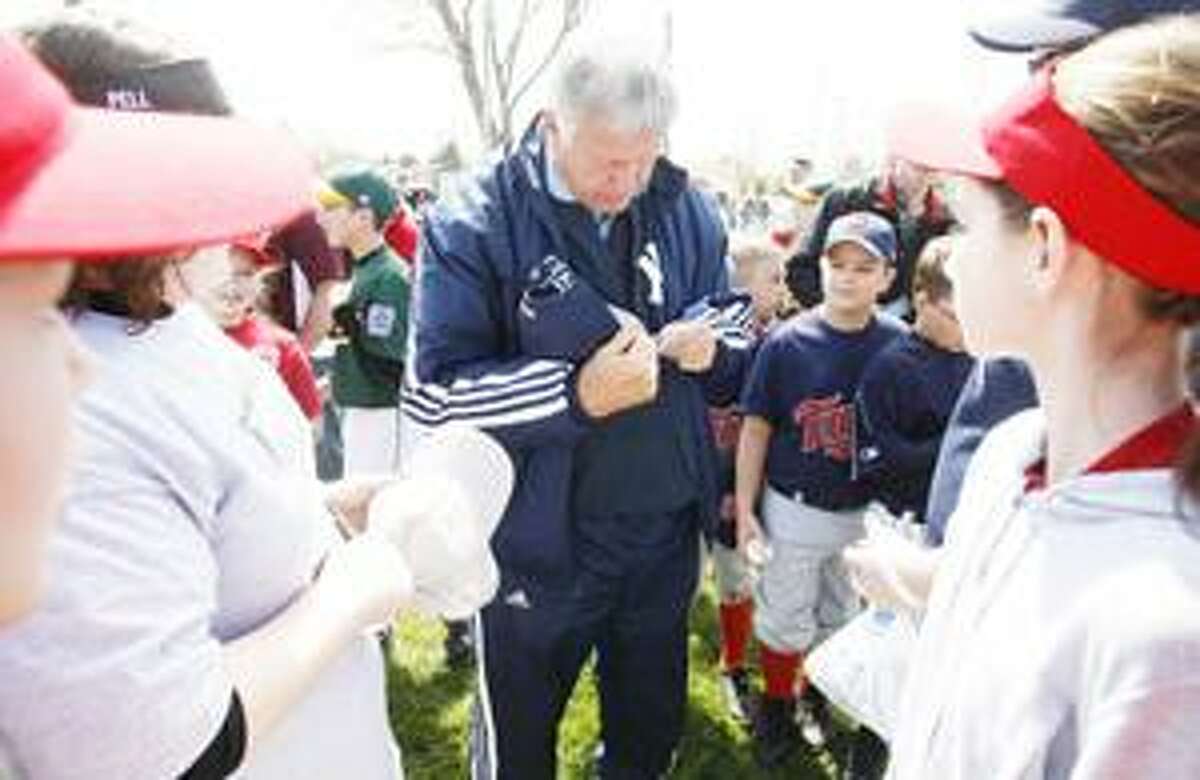 Photo by JOHN HAEGER Former Major League player Tommy John signs autographs after John threw out the first pitch to open the 60th season of Little League in Canastota on Saturday, April 30, 2011.