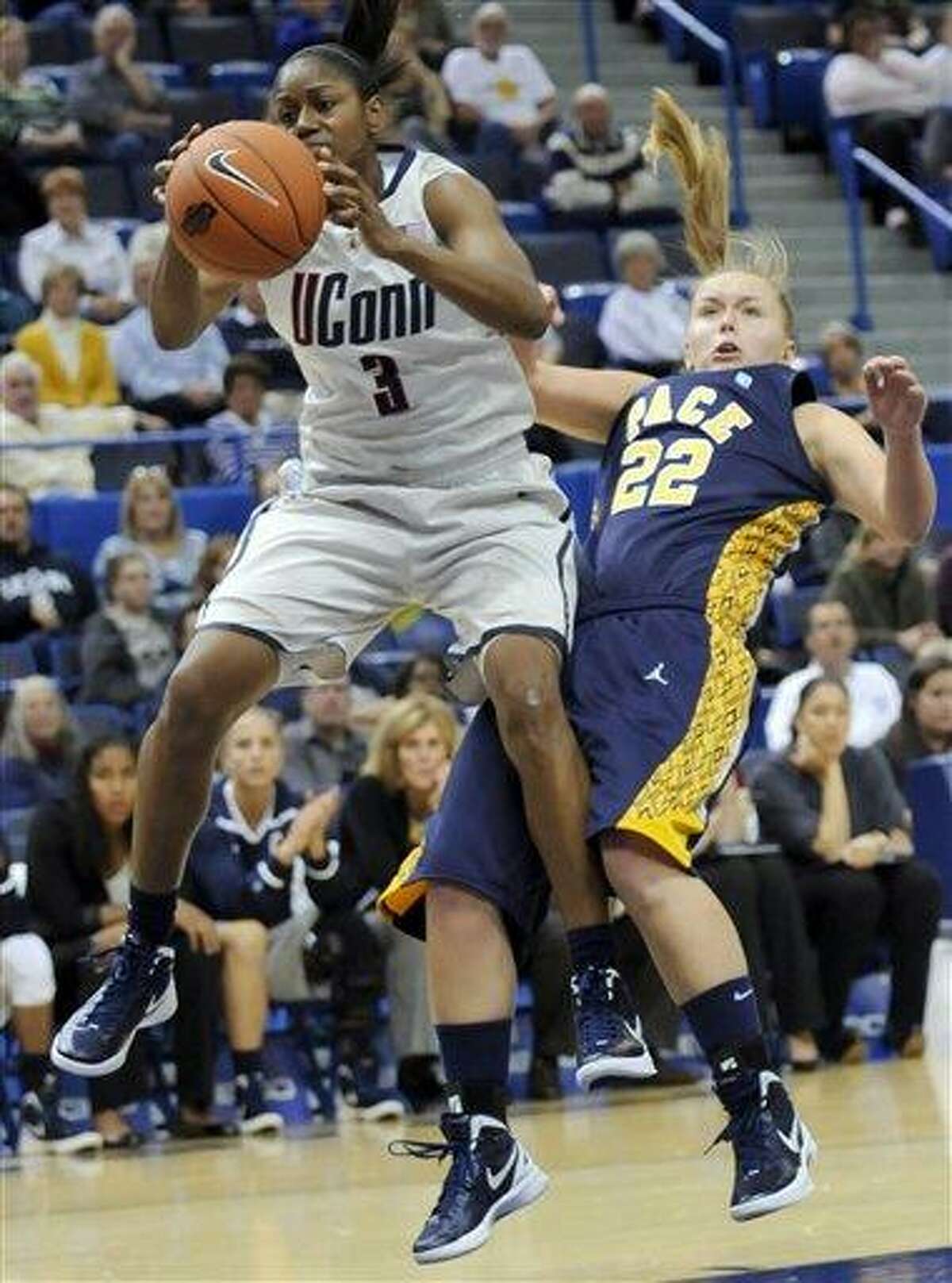 Connecticut's Tiffany Hayes pulls in a rebound past Pace's Margo Hackett in the second half of an exhibition NCAA college basketball game, Wednesday, Nov. 9, 2011, in Hartford, Conn. Connecticut defeated Pace 85-35. (AP Photo/Bob Child)