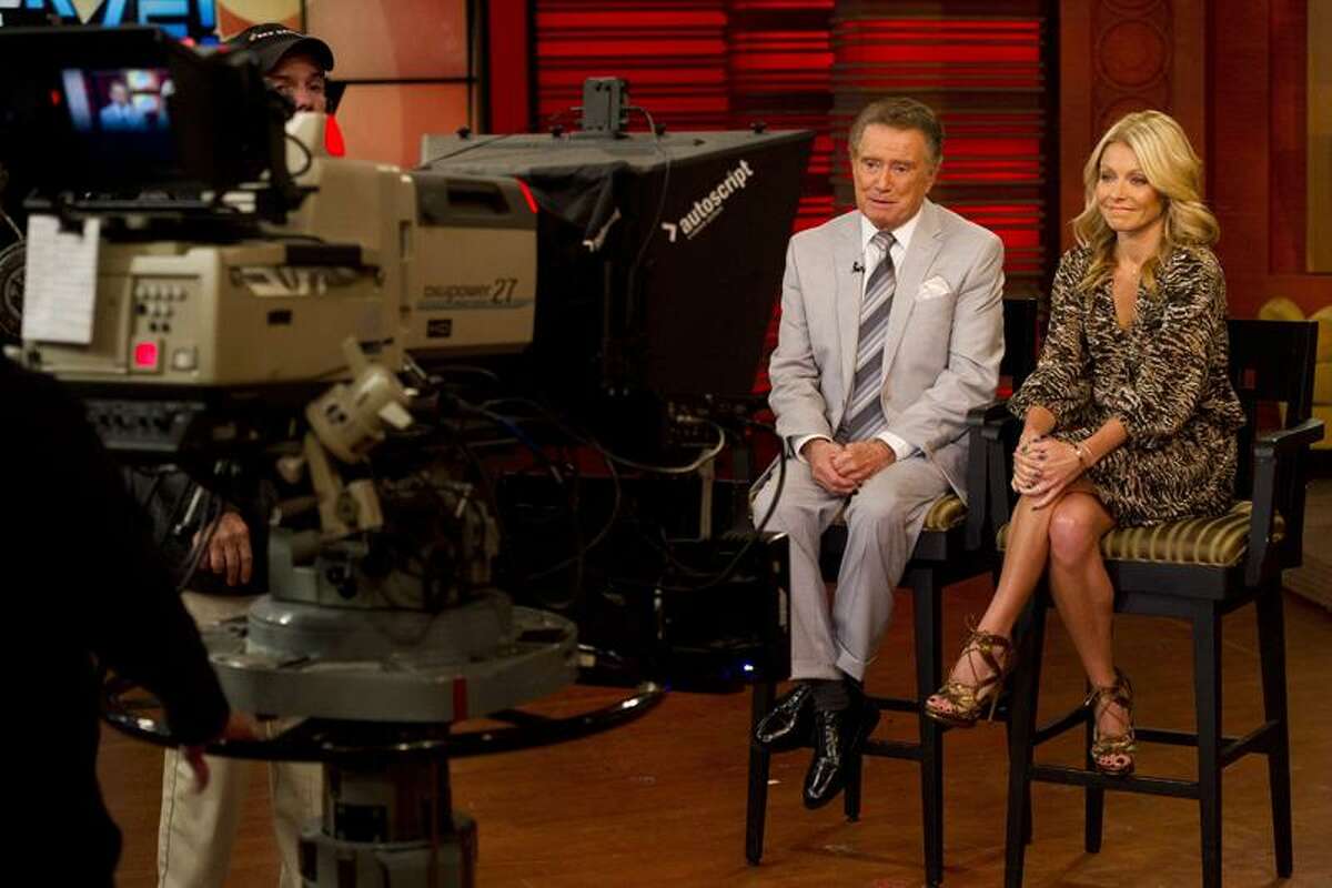 In this Oct. 28, 2011 photo, long-time talk show host Regis Philbin appears with his co-host Kelly Ripa on set during a broadcast of "Live! with Regis and Kelly", in New York. After ruling morning television for 28 years as New York's Everyman-about-town, the co-host who made performance art of TV gab is exiting what for a decade has been known as "Live! With Regis and Kelly." His last day is Nov. 18. (AP Photo/Charles Sykes)