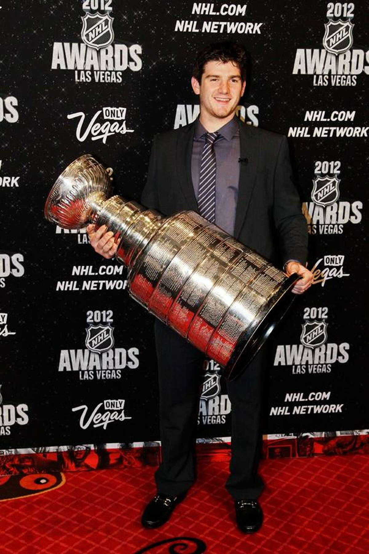 Los Angeles Kings' Jonathan Quick poses with the Stanley Cup before the start of the NHL Awards, Wednesday, June 20, 2012, in Las Vegas. (AP Photo/Julie Jacobson)