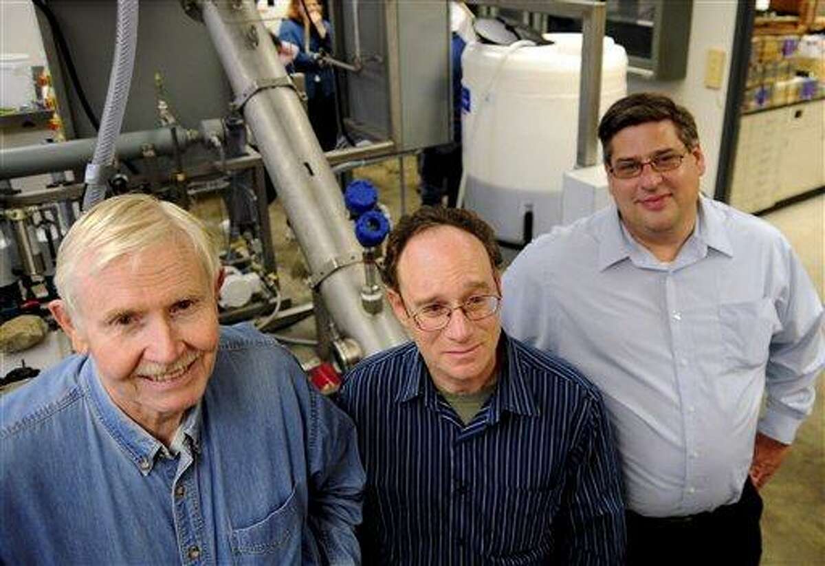 From left, Fred L. Robson, Chief Executive Officer; Richard Parnas, Chief Technology Officer; and Richard Madrak, Chief Operating Officer of RPM Sustainable Technologies, pose with a prototype machine at a University of Connecticut lab in Storrs, Conn. AP Photo/Republican-American, Alec Johnson