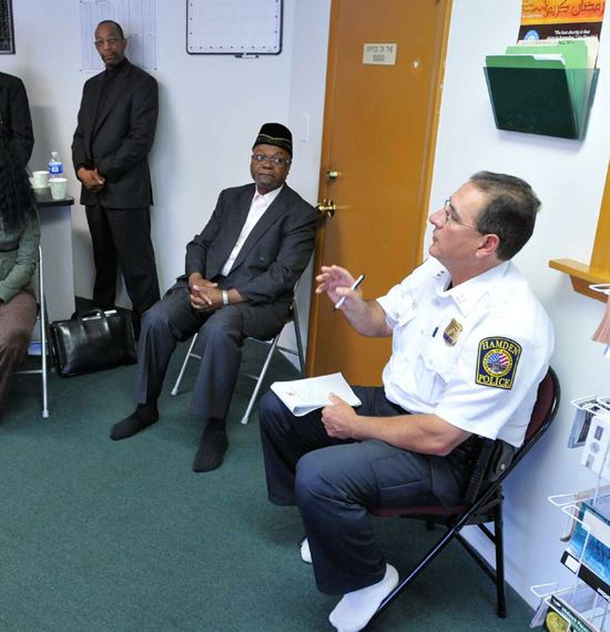 Hamden police Cpt. Ronald Smith talks to residents about violence in the Newhall area of Hamden at the Abdul-Majid Karim Hasan Islamic Center. Peter Casolino/New Haven Register