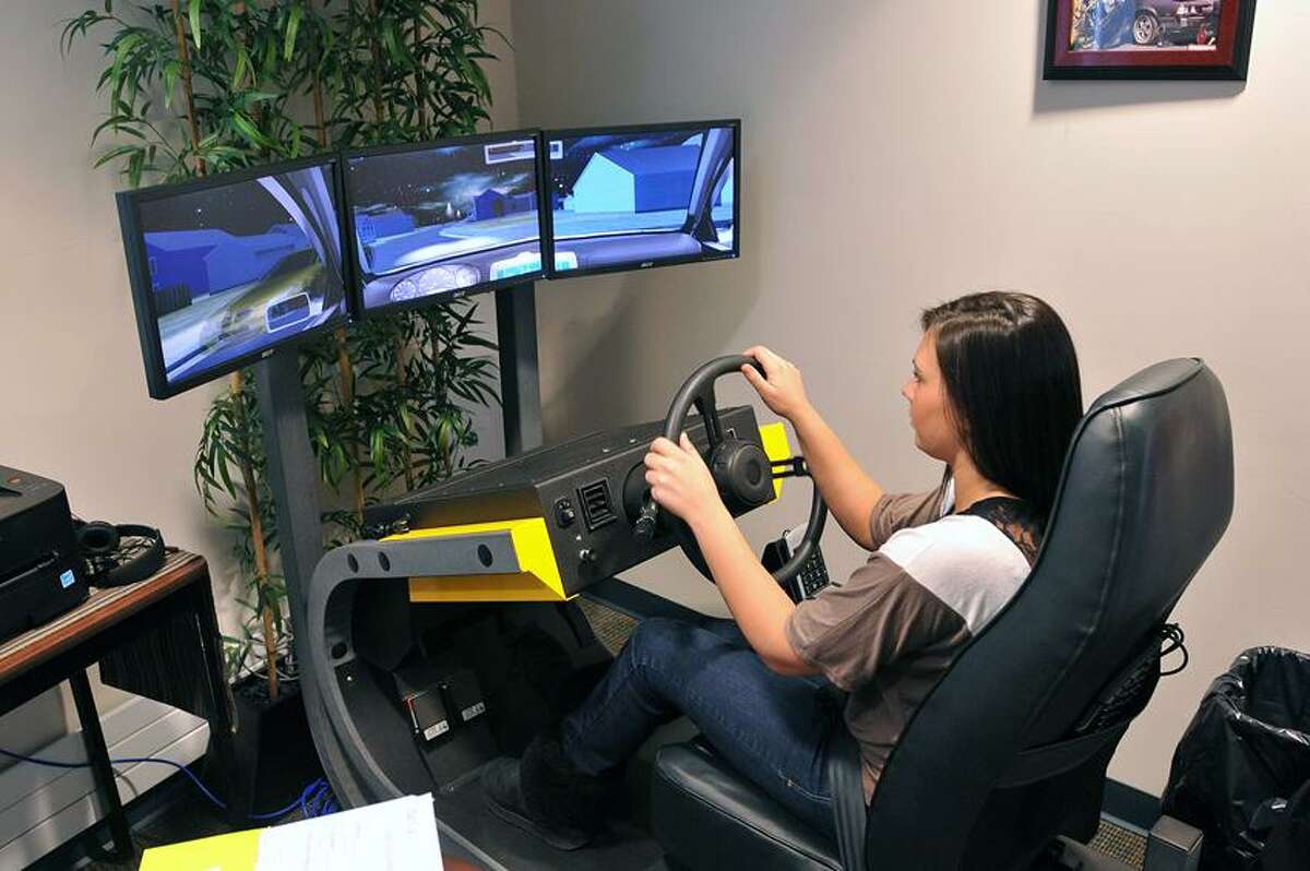 Casey Hayden, a Seymour High senior, uses one of the school's two $80,000 driving simulators donated by Toyota. Peter Casolino/Register