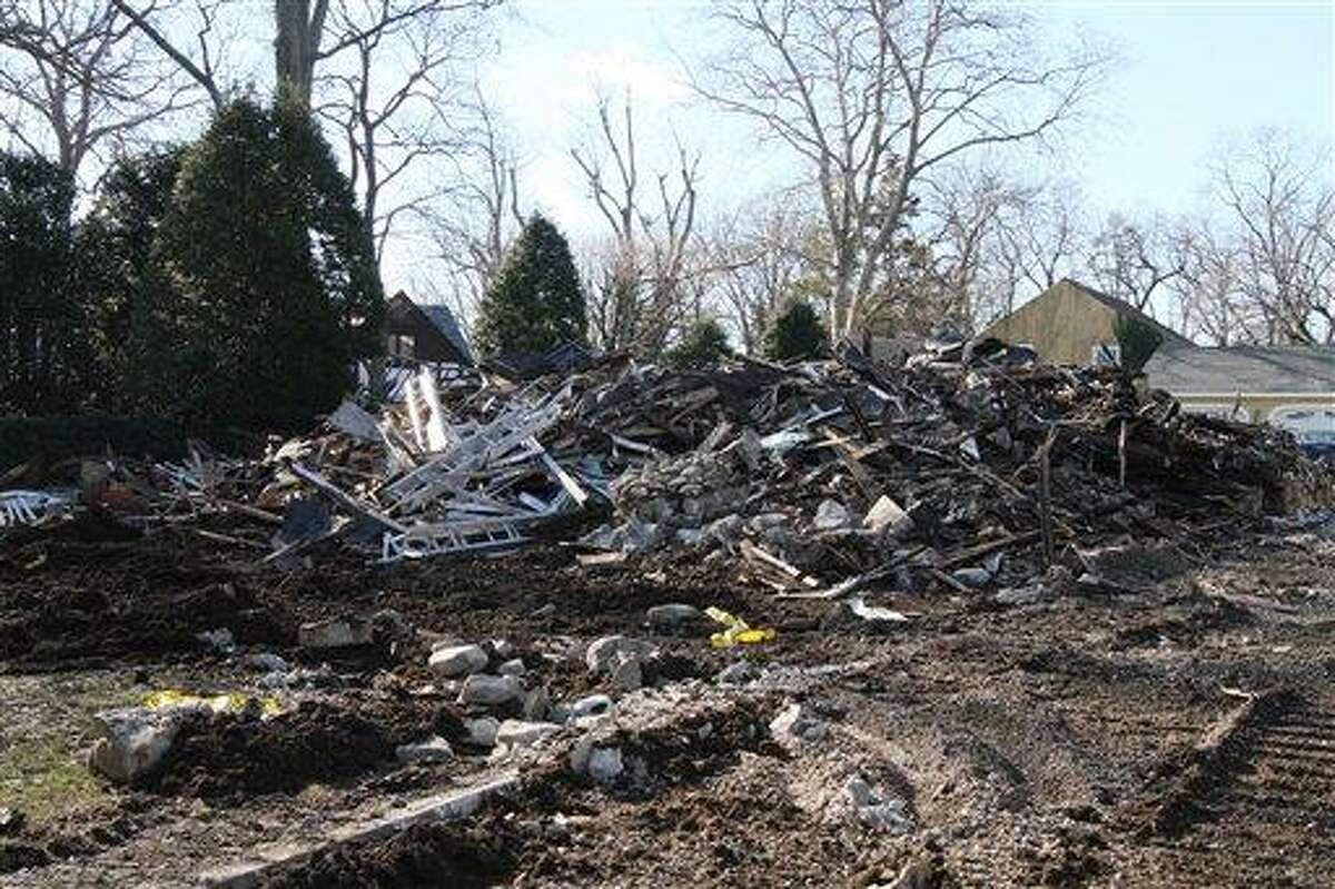 Rubble left after the demolition of a house where a fire left five people dead Christmas Day lies on the ground, Monday, Dec. 26, 2011, in Stamford, Conn. (AP Photo/Tina Fineberg)