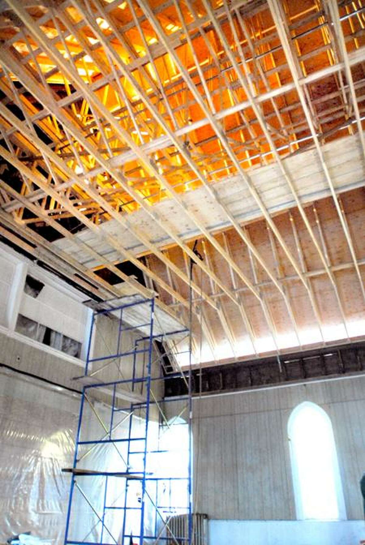 The roof under construction can be seen in the sanctuary at the New Light Holy Church on Howard Avenue in New Haven. Photo by Arnold Gold/New Haven Register
