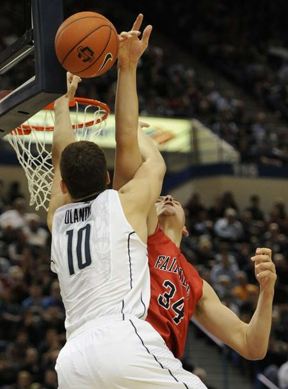 Fairfield's Ryan Olander, right, blocks a dunk attempt by his brother, Connecticut's Tyler Olander, left, during the second half of an NCAA college basketball game in Hartford, Conn., Thursday, Dec. 22, 2011. Connecticut won 79-71. (AP Photo/Jessica Hill)