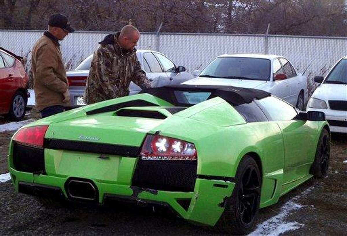David Dopp, of Santaquin, Utah, who crashed the Lamborghini Murcielago he won in a convenience store contest shortly after being handed the keys in November, looks over the damage to his car Tuesday, Dec. 20, 2011 at a Utah towing yard. Dopp now plans to sell the $300,000 640-horsepower convertible because he can't afford the insurance or taxes. (AP Photo/KSL-TV via The Deseret News, Alex Cabrero) SALT LAKE TRIBUNE OUT; PROVO DAILY HERALD OUT; MAGS OUT