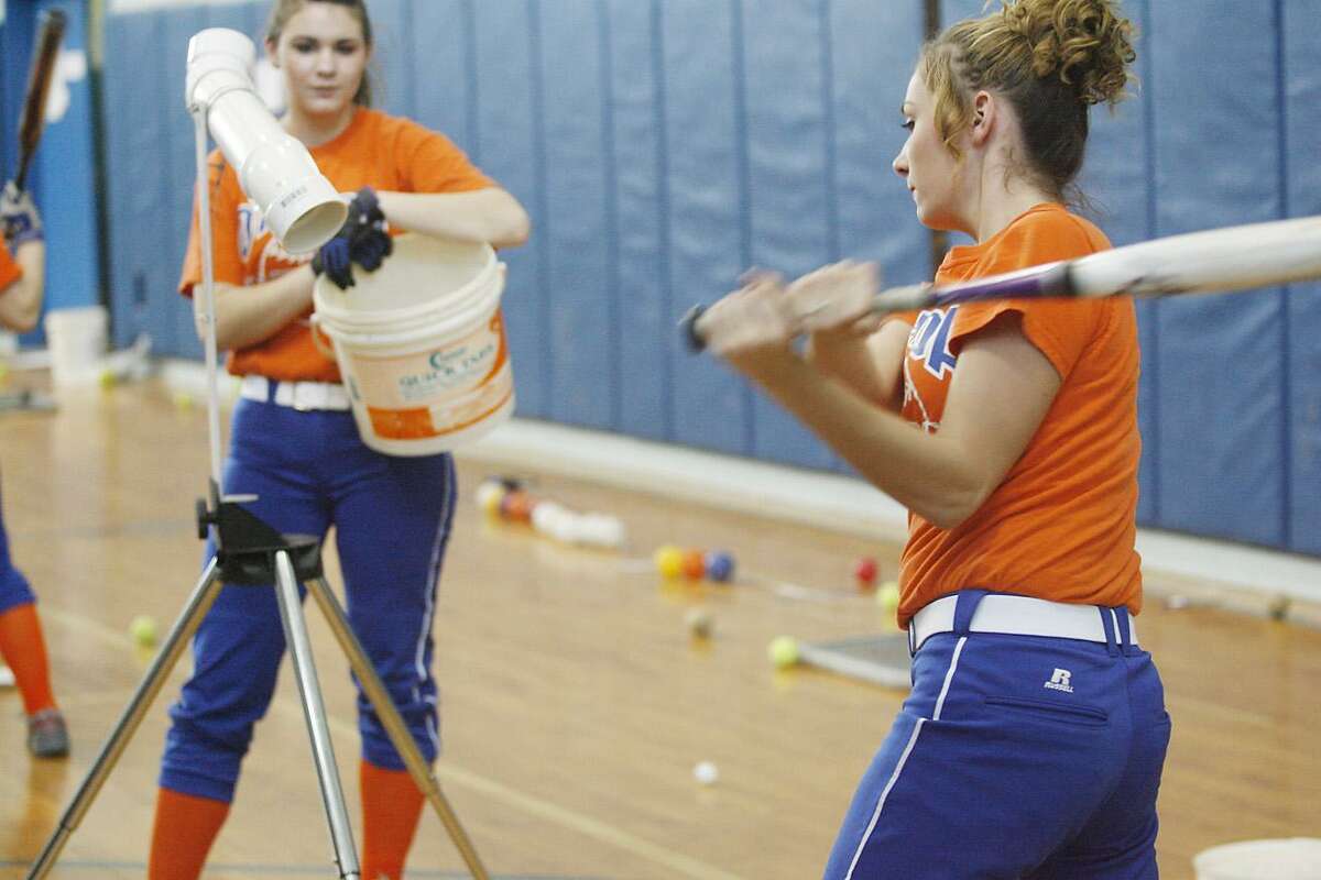 Dispatch Staff Photo by JOHN HAEGER Oneida's Samantha Savage and Carley Herb (batting) works on a hitting drill on March 29, 2011.