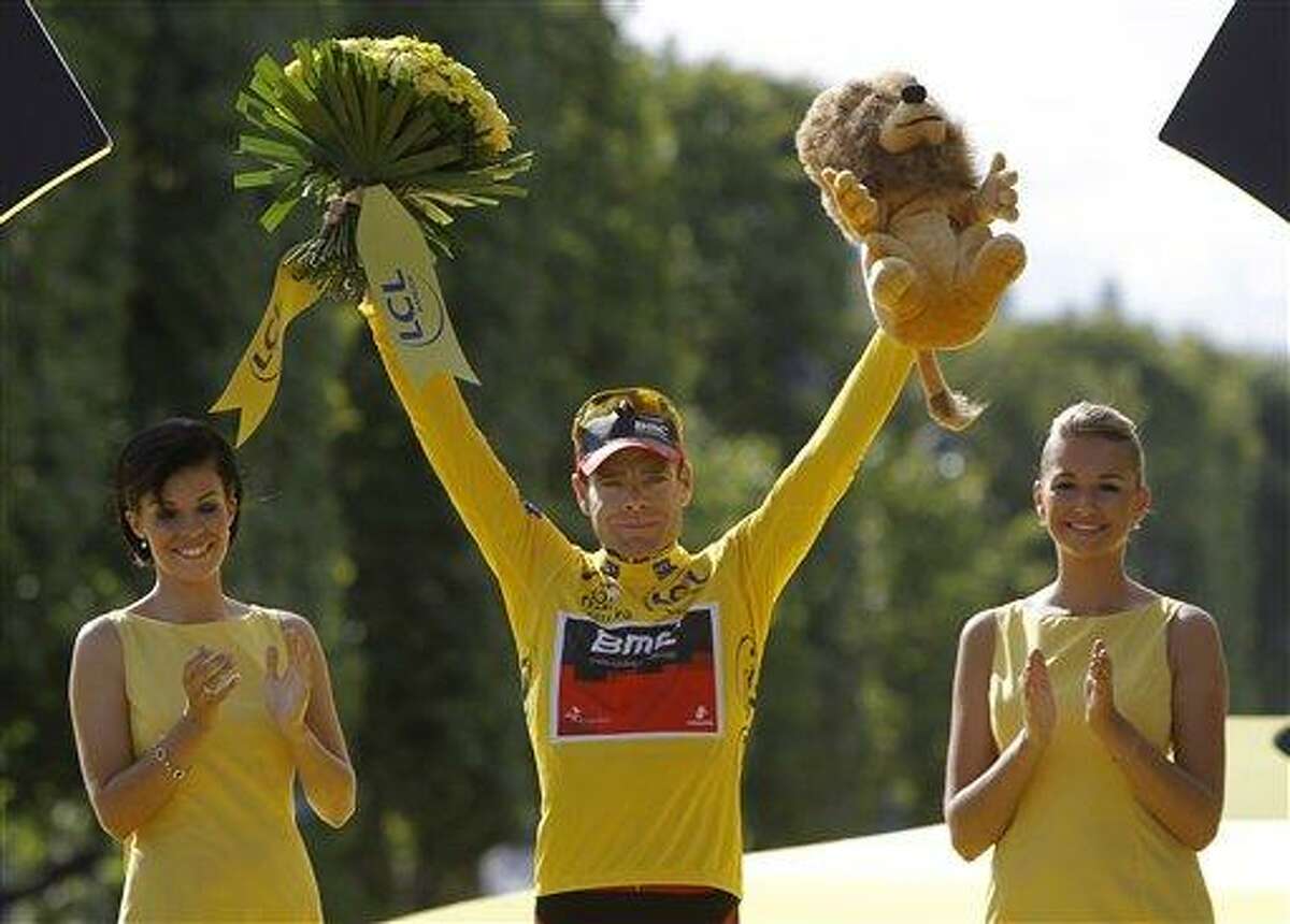 Tour de France winner Cadel Evans of Australia, wearing the overall leader's yellow jersey, stands on the podium after winning the Tour de France cycling race in Paris, France, Sunday July 24, 2011. (AP Photo/Laurent Cipriani)