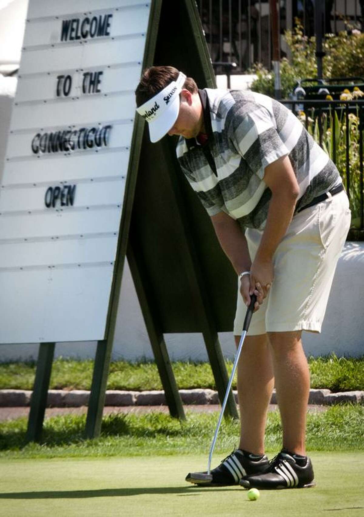 Mike Ballo Jr., of Stamford, practices putting after completing the first round at Connecticut Open. Ballo held a 1-shot lead. Melanie Stengel/Register