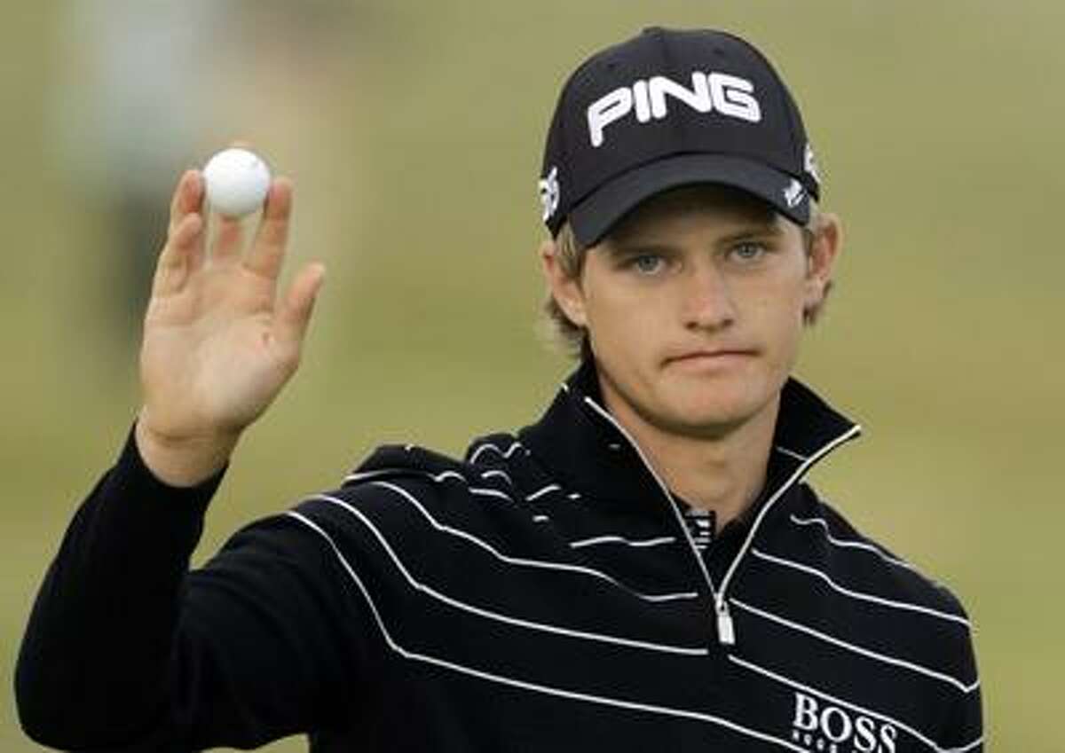 RECROP OF XSDW405 England's Tom Lewis reacts after putting on the 18th green after finishing his round during the first day of the British Open Golf Championship at Royal St George's golf course Sandwich, England, Thursday, July 14, 2011. (AP Photo/Peter Morrison)
