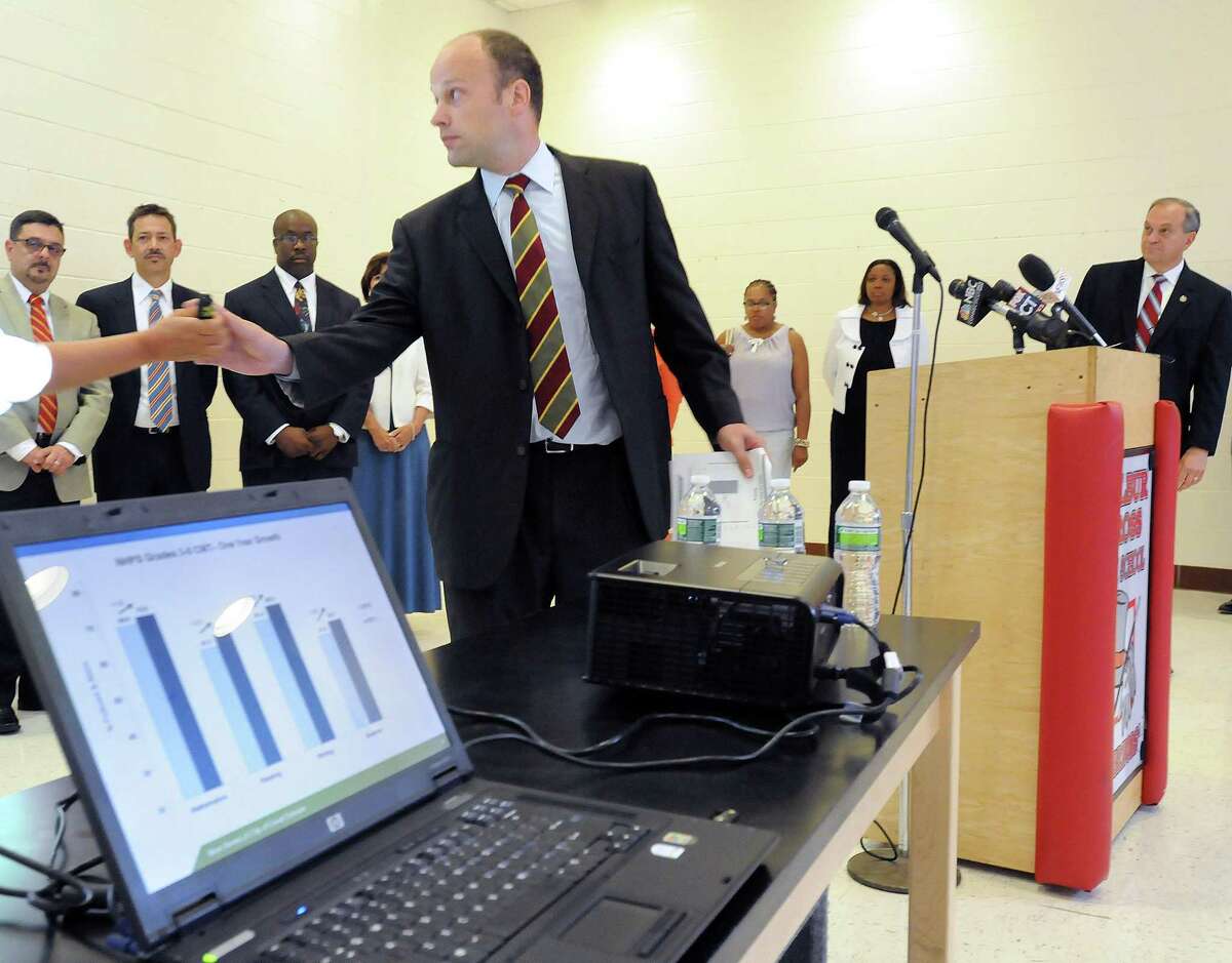 At Wilbur Cross High School New Haven officials announced the latest CMT and CAPT scores. Assistant superintendent of schools Garth Harries makes a power point presentation. Photo by Mara Lavitt/New Haven Register7/13/11