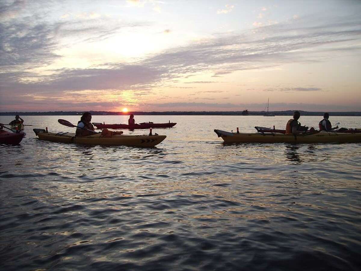 Martin Torresquintero photo: Paddlers will be out on the water after sunset Thursday night at Lighthouse Point Park in New Haven.