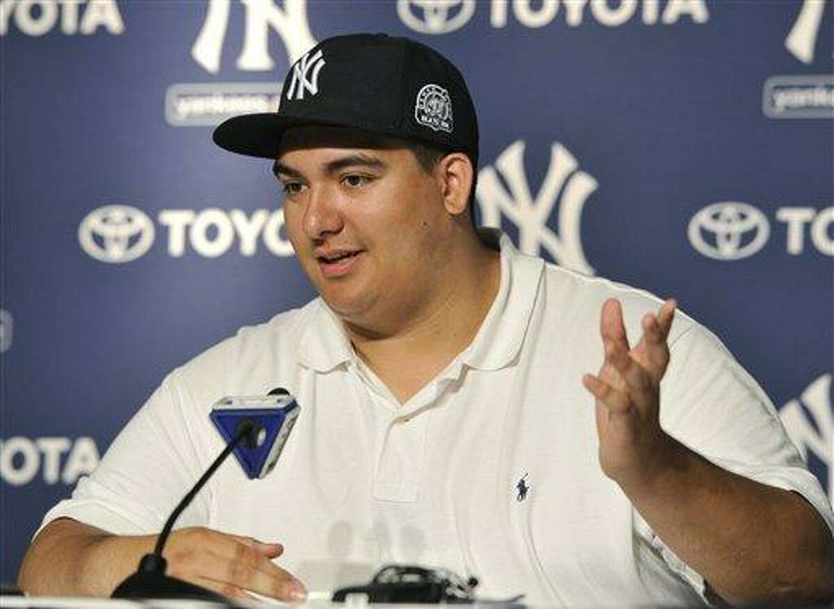 Christian Lopez speaks about catching New York Yankees' Derek Jeter's 3, 000th career hit ball at a press conference after the baseball game against the Tampa Bay Rays on Saturday, July 9, 2011 at Yankee Stadium in New York. The Yankees won 5-4. (AP Photo/Kathy Kmonicek)