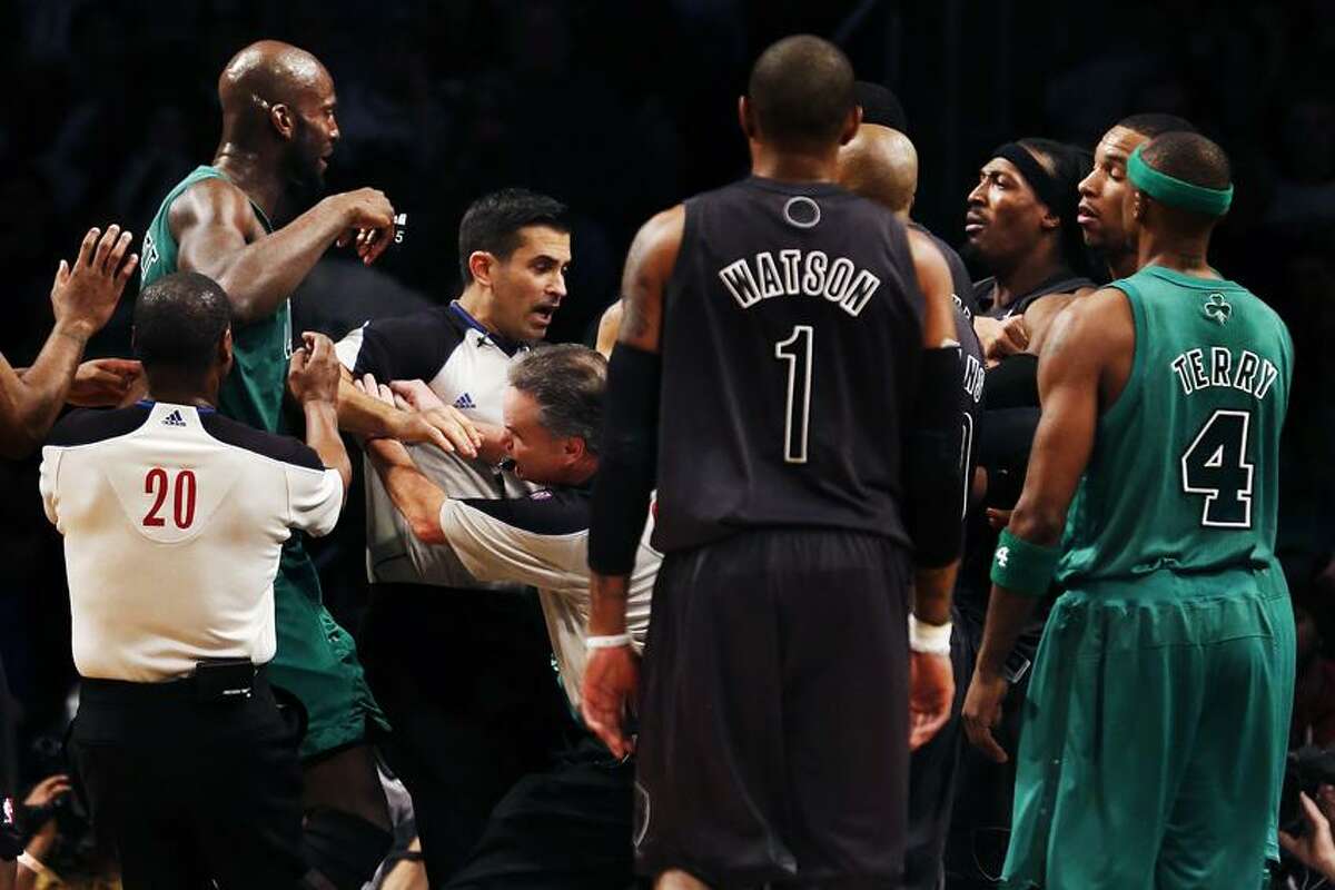 Boston Celtics' Kevin Garnett, far left, and Brooklyn Nets forward Gerald Wallace, third from right, are separated by officials in the second half of their NBA basketball game at Barclays Center, Tuesday, Dec. 25, 2012, in New York. Boston won 93-76. (AP Photo/John Minchillo)