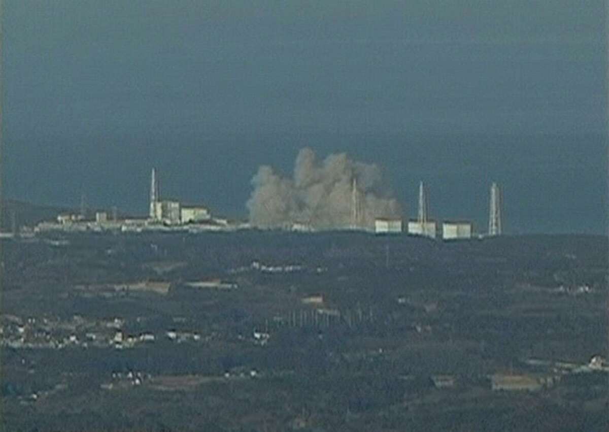 In this video image taken from NTV Japan via APTN, smoke raises from Fukushima Daiichi power plant's Unit 1 in Okumamachi, Fukushima prefecture, Japan, Saturday, March 12, 2011. The walls of a building at the nuclear power station crumbled Saturday as smoke poured out, and Japanese officials said they feared the reactor could melt down following the failure of its cooling system in a powerful earthquake and tsunami. (AP Photo/NTV Japan via APTN)