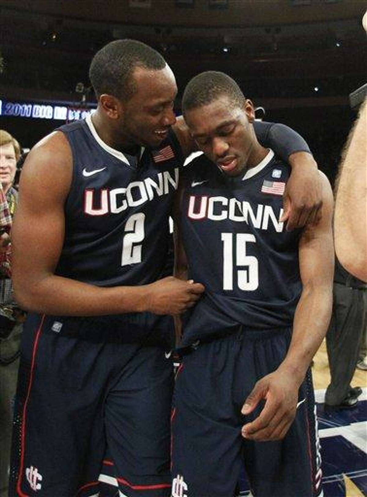 Connecticut's Donnell Beverly (2) celebrates with teammate Kemba Walker (15) after an NCAA college basketball game against Louisville at the Big East Championship Saturday, March 12, 2011, in New York. Connecticut won the game 69-66. (AP Photo/Frank Franklin II)