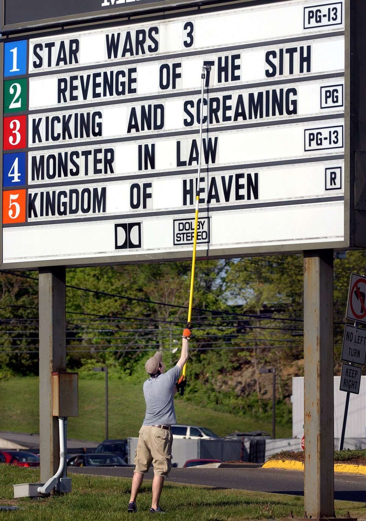Kevin Wright of Milford, an usher at Showcase Cinemas in Milford changes out the signage to advertise the new Star Wars movie.