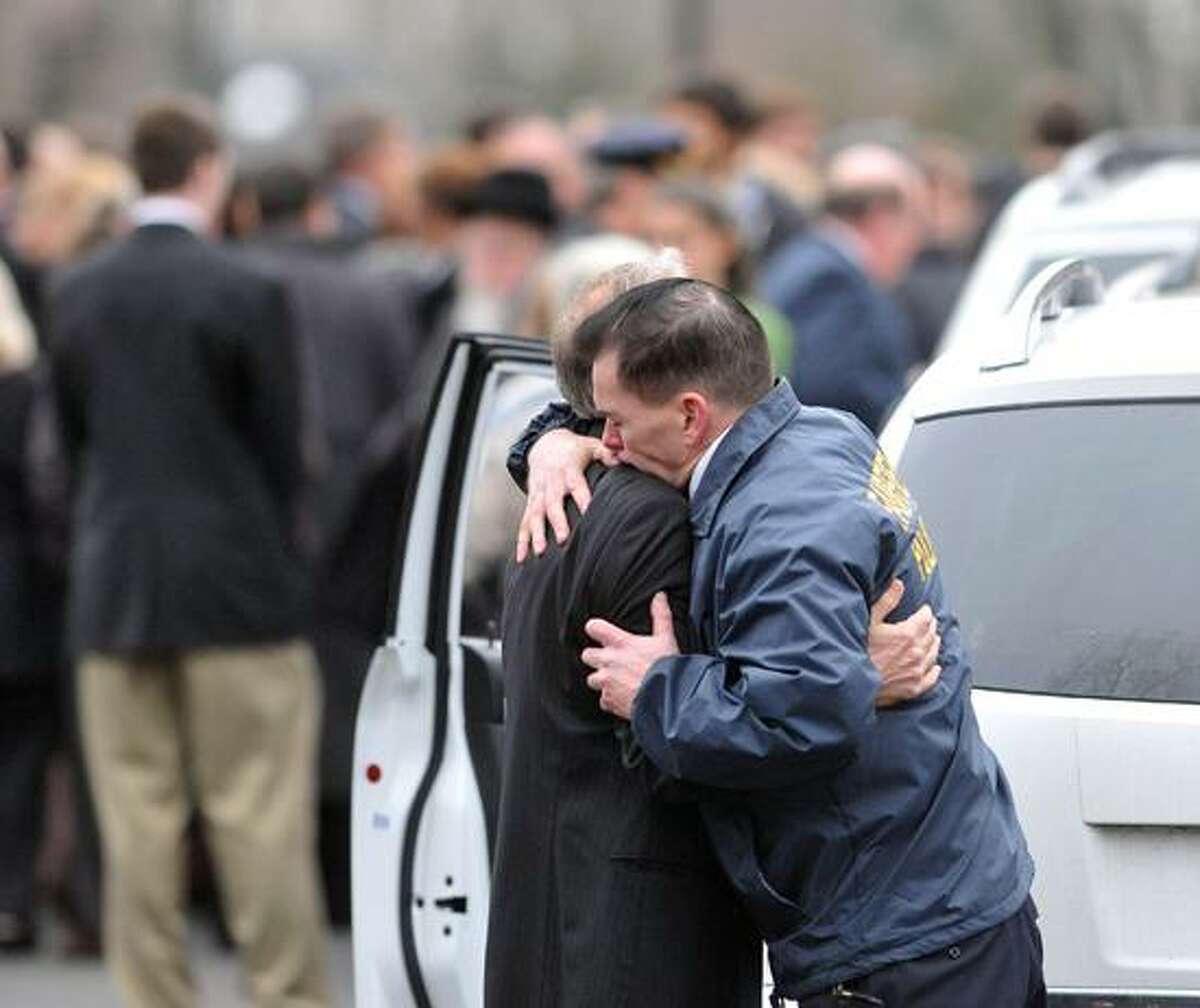 Fairfield--Fairfield Police Chief hugs a family member outside the Abraham L. Green & Son Funeral Home in Fairfield after services for Noah Pozner, 6, victim of the Sandy Hook Elementary School massacre. Photo-Peter Casolino 12/17/12,