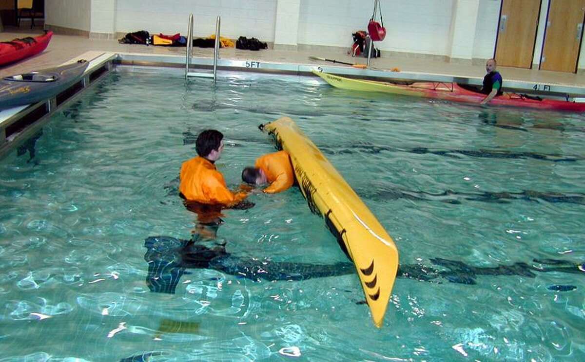 Martin Torresquintero photo: An instructor is close at hand when paddlers learn how to do an eskimo roll at one of the city's kayak clinics at Hillhouse High.