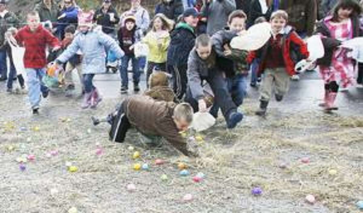 Photo by JOHN HAEGER Children search for the 5,000 eggs placed out during the annual Lenox Easter Egg Hunt on Saturday, April 23, 2001 in the Village of Canastota.